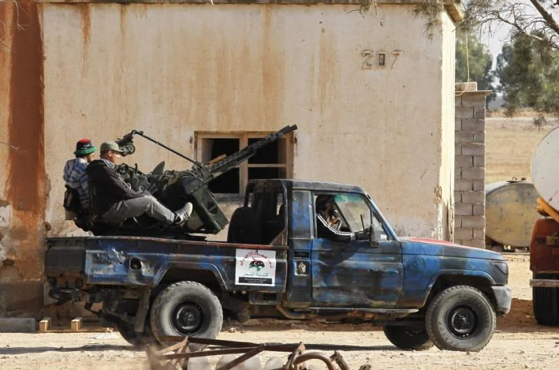 105108-libyan-rebel-fighters-drive-a-pickup-truck-at-misratas-western-front-l.webp