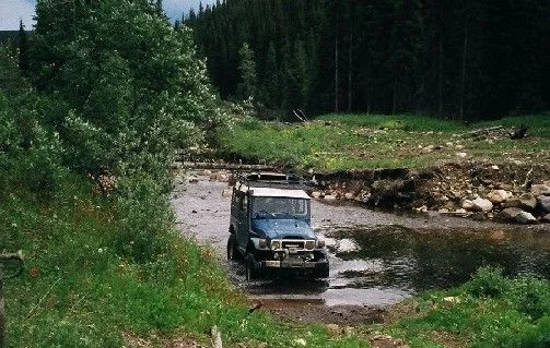 2. Me driving thru creek.webp