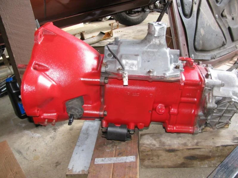 Bellhousing and tranny painted red just before install on engine.webp