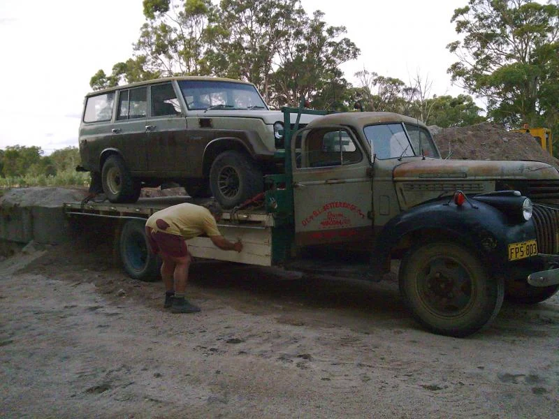 dad tying the lcruiser onto the chev.webp