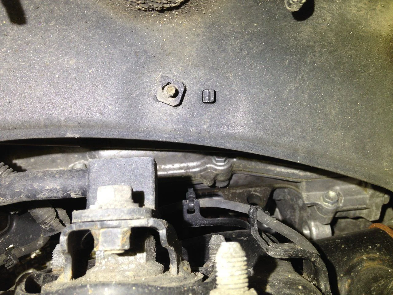 DS valve cover gasket leak above wheel well.webp