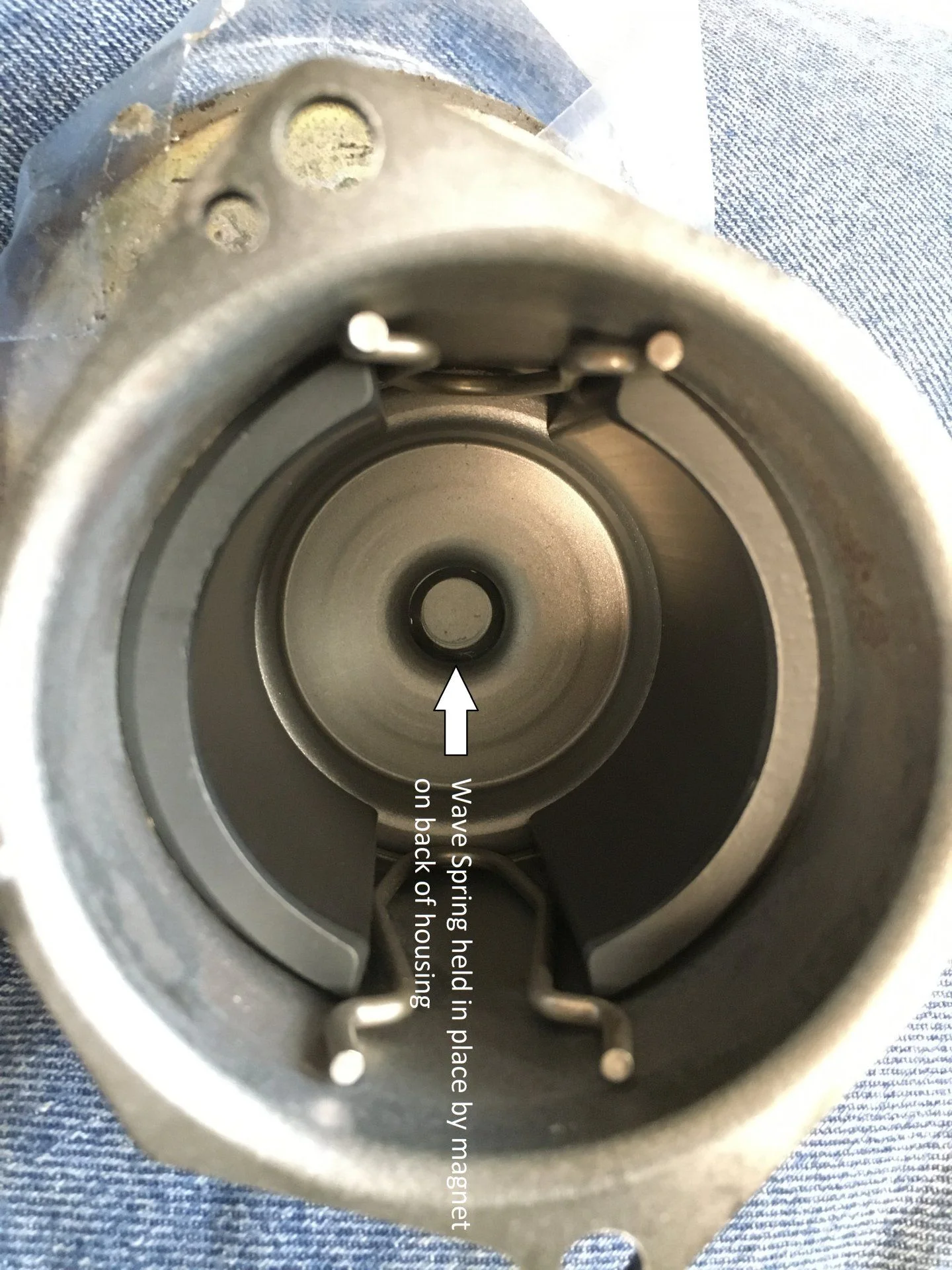 Housing before assembly, wave spring held in bearing pocket by magnet.webp