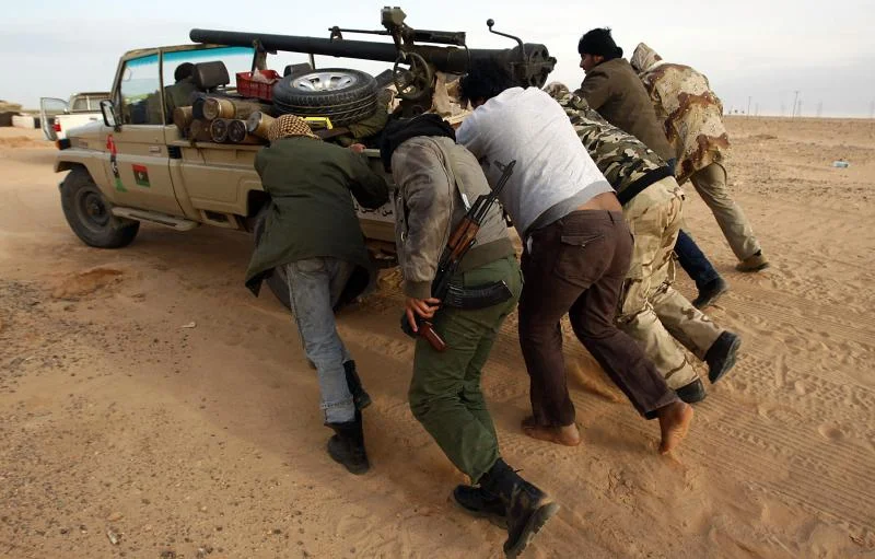 libyan rebels push a truck.webp