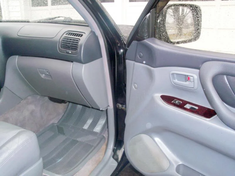 Passenger door open and glove box.webp