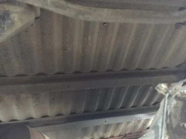 Red - Floor between spare & axle & gas tank.webp
