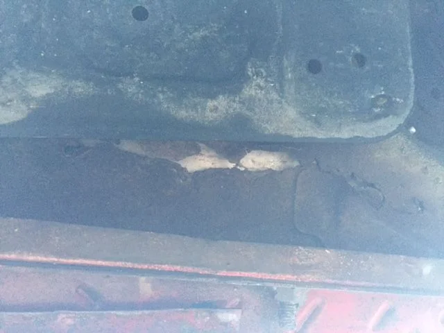 Red - Floor rust beneath rear of seat area.webp