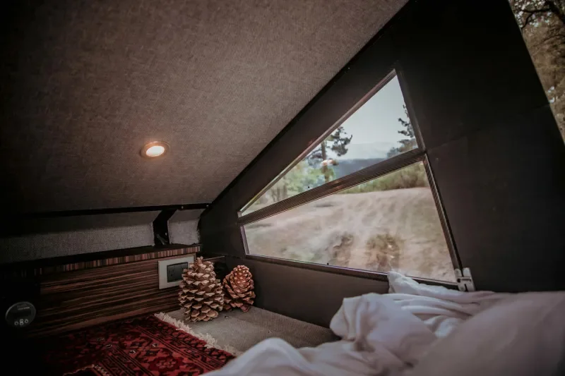 redtail-overland-skyloft-camper-van-penthouse-bedroom.webp