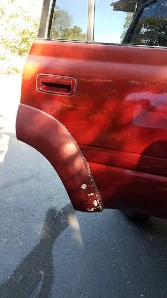 right rear door with paint blemishes.webp