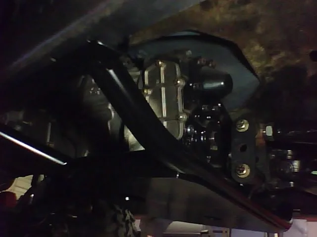 Skidplate installed at traction bar Side View.webp