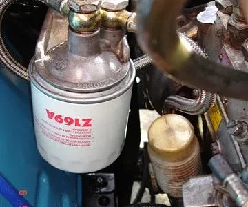 Moved the fuel filter from "the intake manifold" to "the battery support" to provide more room below it and thus allow deeper (& cheaper & more readily-available) cartridges to be fitted.