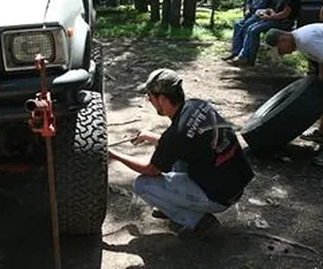 Tyler changes a blown tire on his truck.