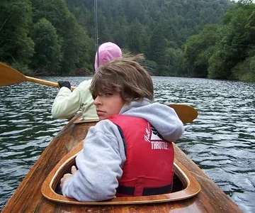 Son and wife in triple kayak.  This is just before my son caught my nose and lip with a treble hook castmaster on the back cast.  I was proud of the way he set the hook.