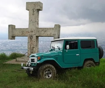 A large concrete cross covered in graffitti... My wife and I repainted this cross to pay tribute to the my wifes heritage, and as a memorial for my late Grandmother (Grammy).