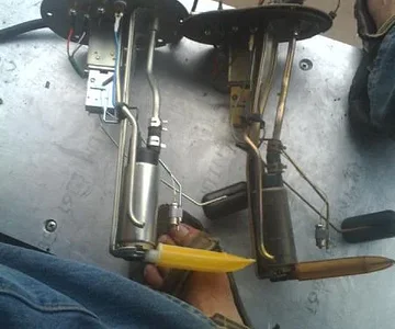 Old vs. new OEm fuel pump bracket and parts.