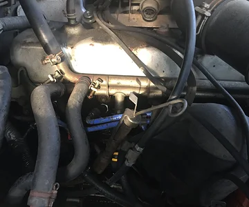 hole where oil leak is next to spark plug