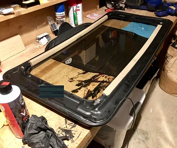 Sunroof out of the vehicle and resting on the workbench