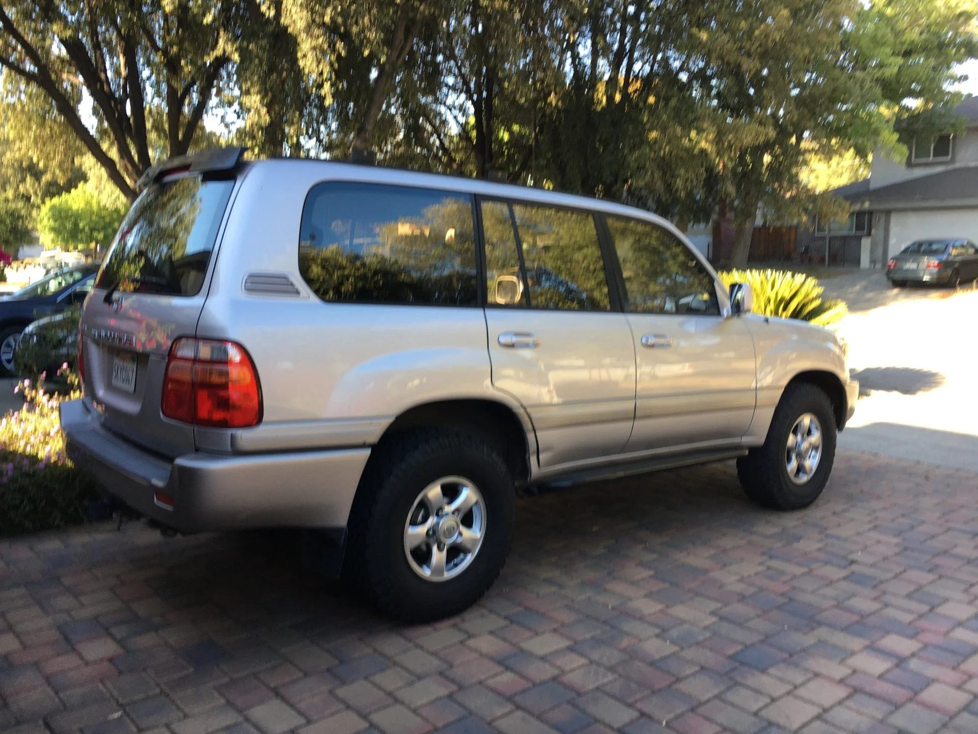 2002 silver 100 series with 151k miles. Note ding on passenger rear door, lower and on tailgate, inward of passengar tail light