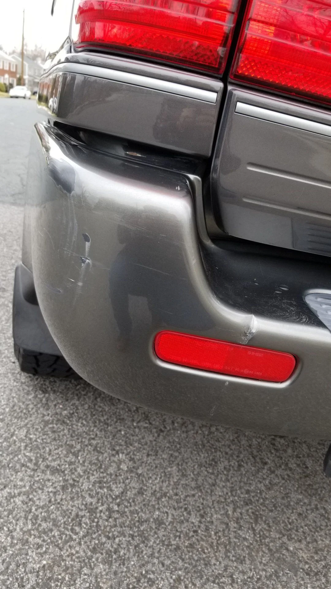 Another Close view of scratches/dent left rear bumper