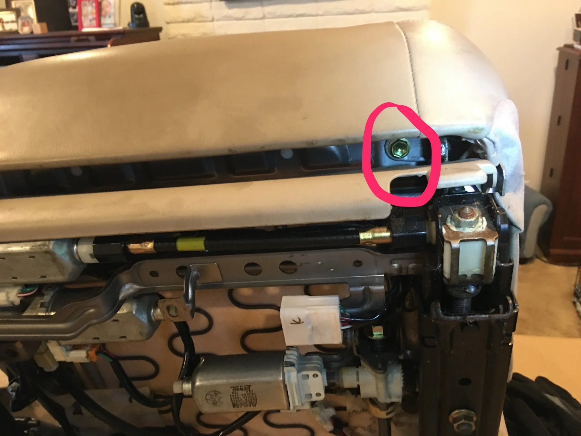 Bottom bolt under seat (at front)