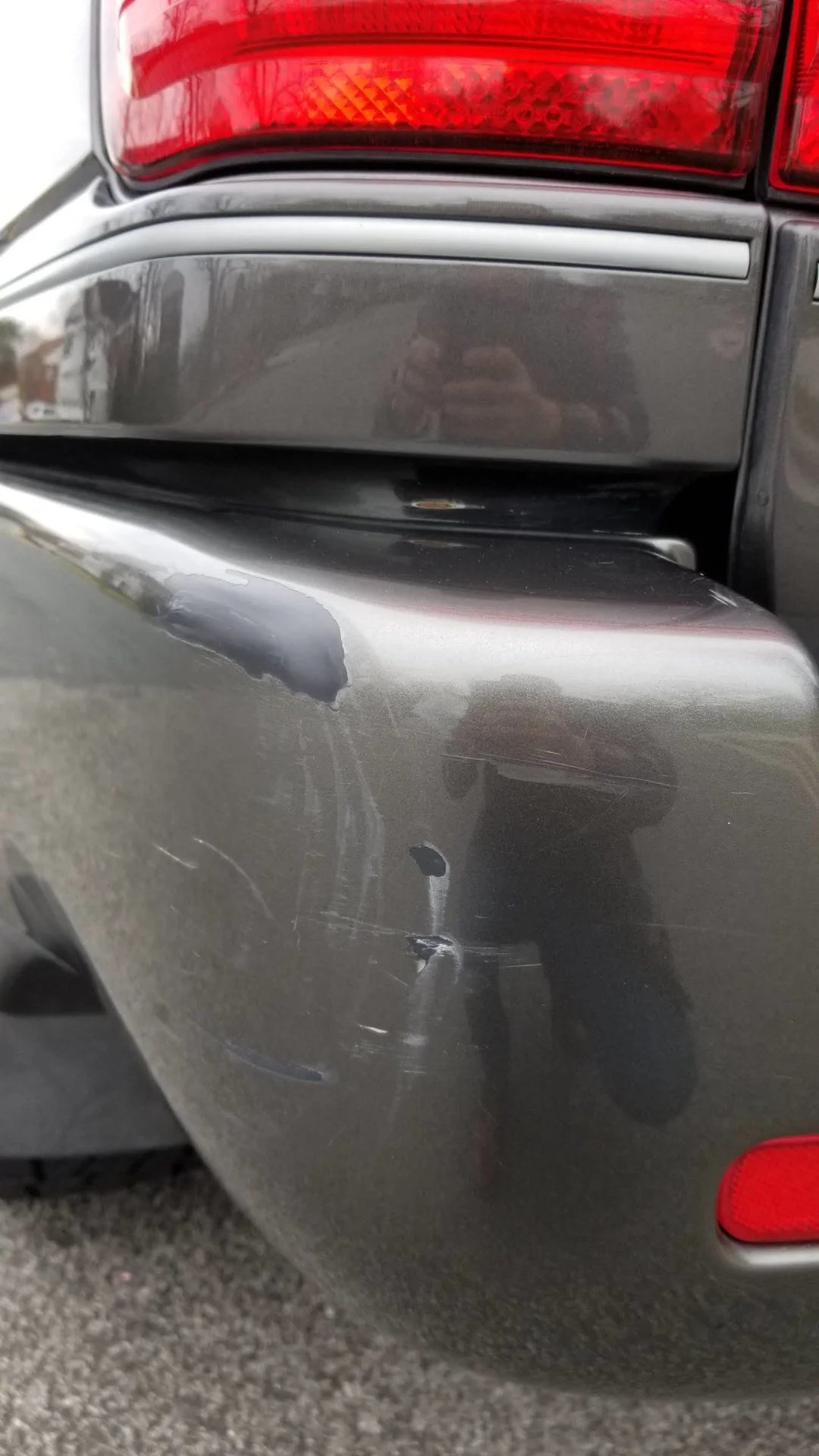 Close-up view of scratches/dent left rear bumper