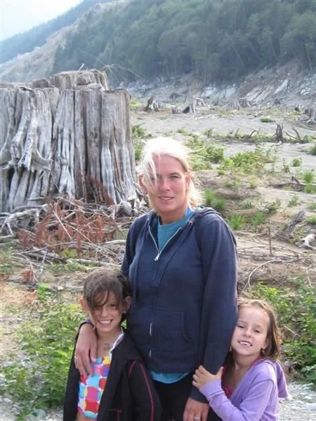 family standing in front of what used to be the campsite