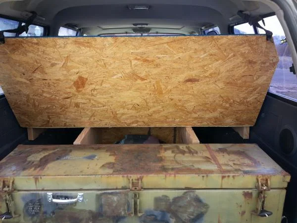 Hinged section held up using seat straps