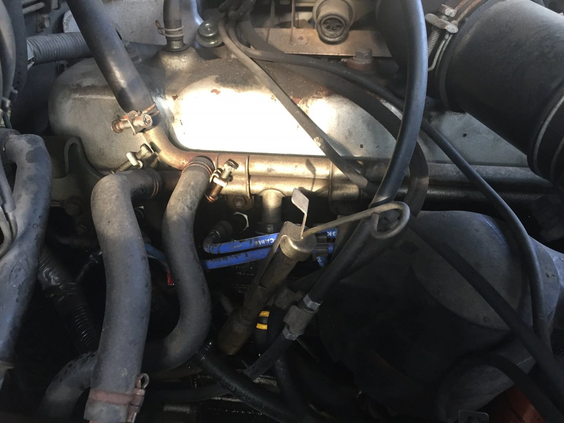 hole where oil leak is next to spark plug