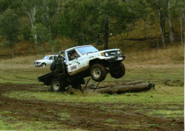me jumping my mud racer and my 62 series in the background