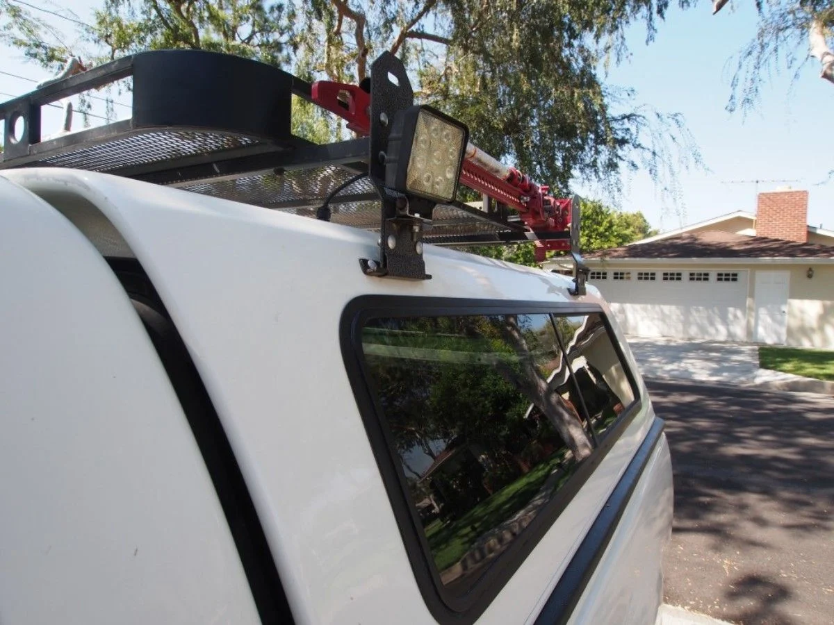 Off-road lights mounted to the van ladder rack.