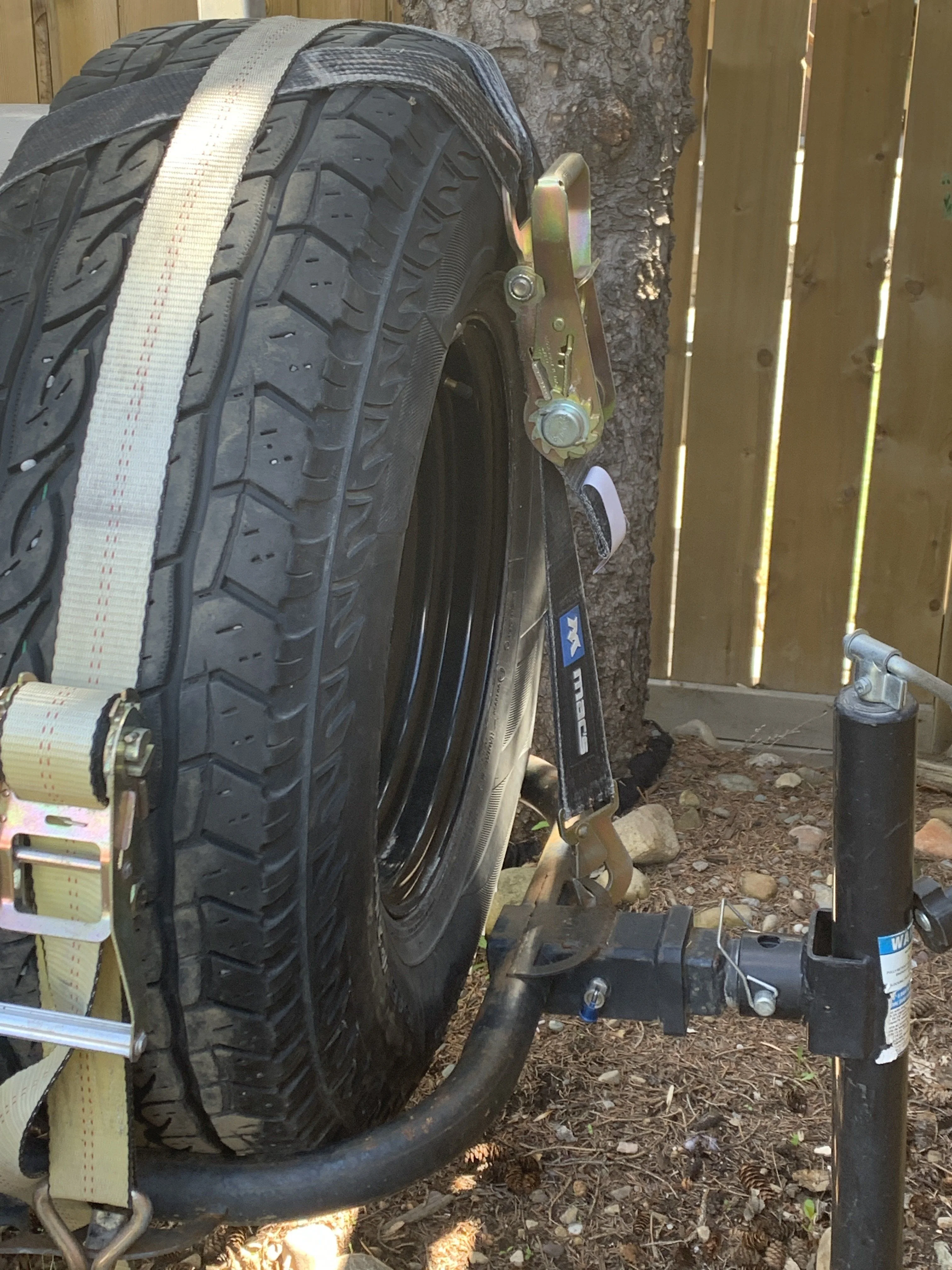 Rear tire carrier with Mac Strap and stand.JPG