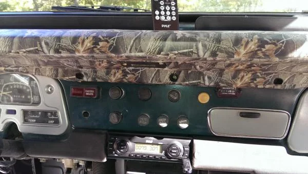 Redneck dash cover, mossy oak duct tape.  Also digital head unit, no CD but aux and USB inputs. Best thing I have done in awhile