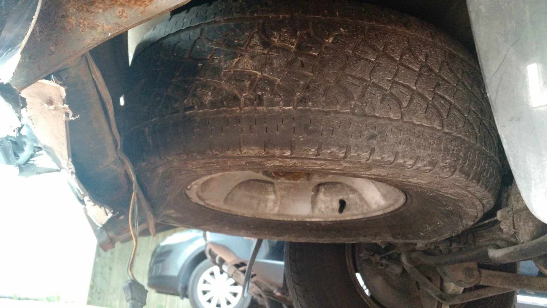 Spare tire is deformed as frame folded under