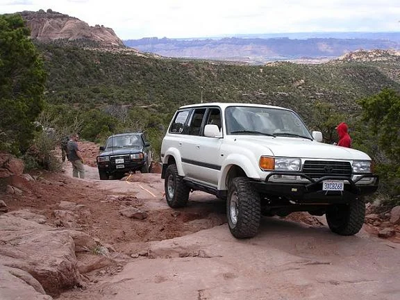 Strapping an 80 up a ledge Porcupine rim trail Moab 2010