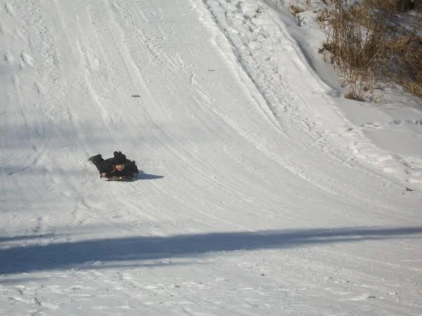 The girl sledding down the 30m