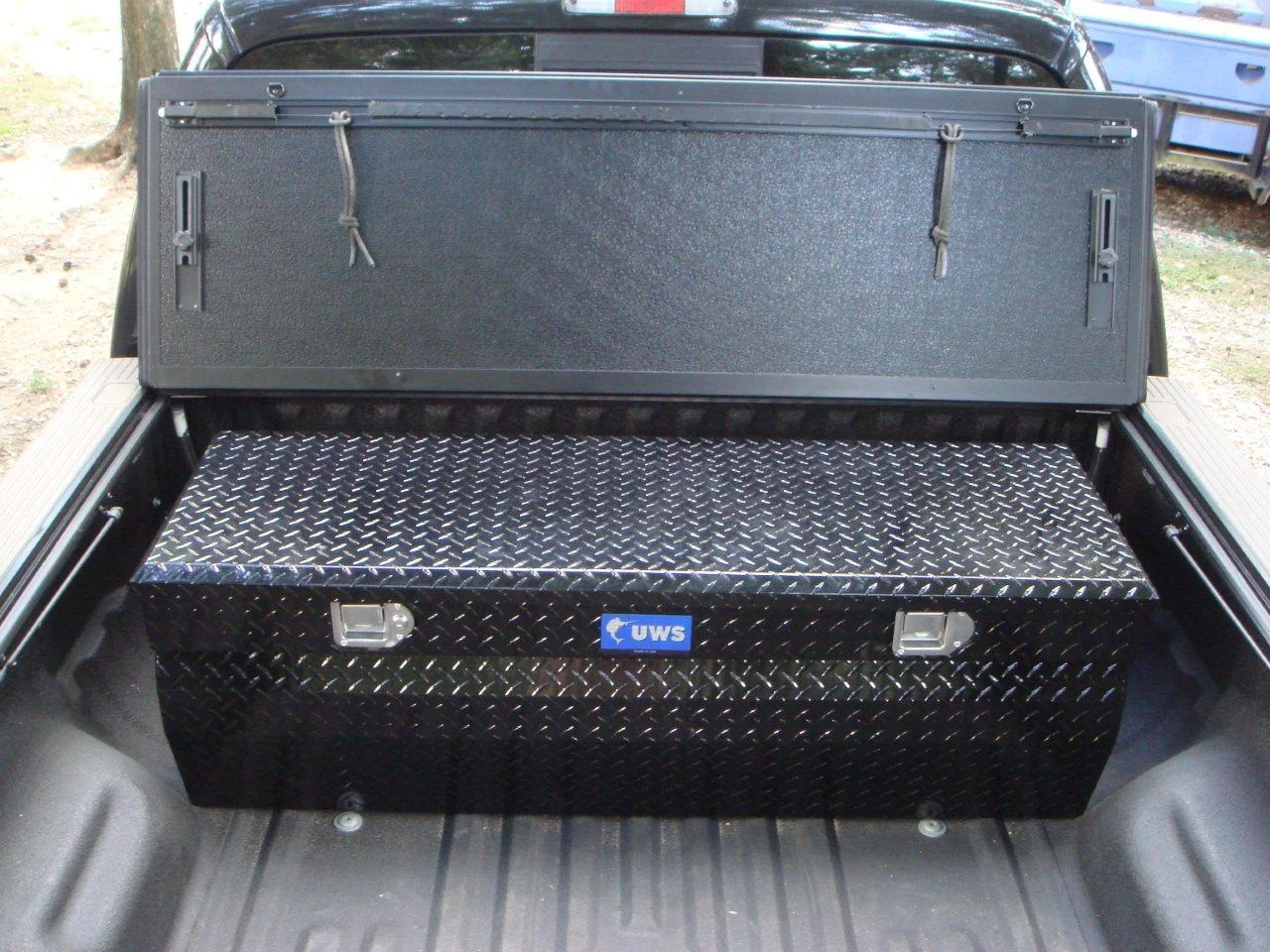 Tool box is flush under bed cover.