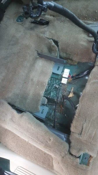 Under driver's seat (rhs)