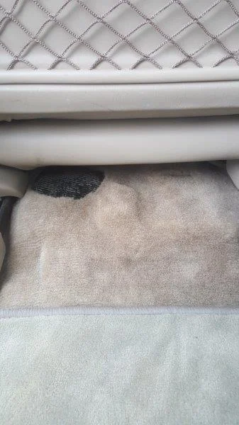 Under passenger seat (lhs)